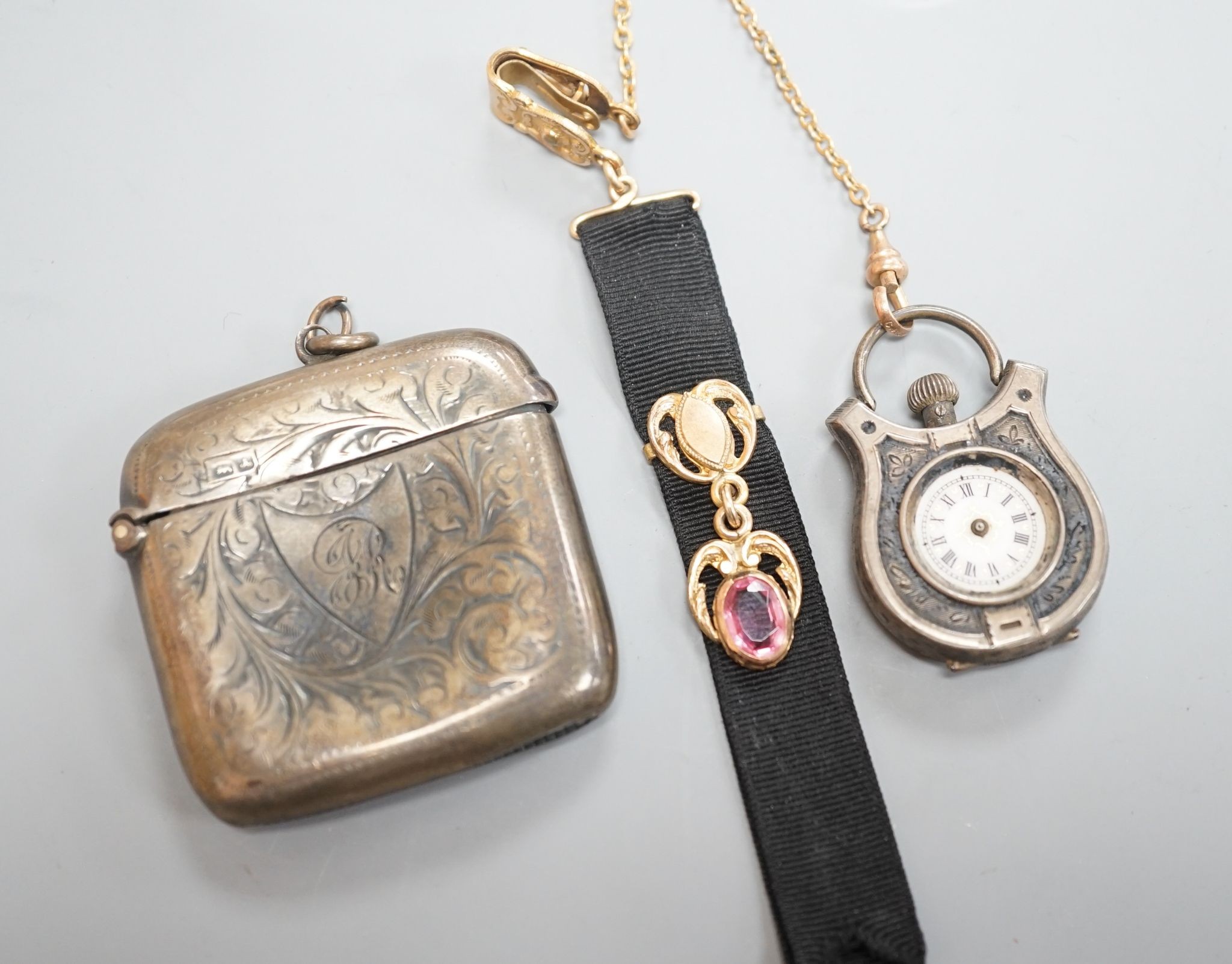 A silver vesta case, 48mm and a white metal cased fob watch, on a black sash suspension.